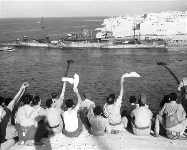 The convoy entering the harbour. Troops wave and cheer as more boats of the convoy