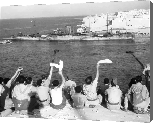 The convoy entering the harbour. Troops wave and cheer as more boats of the convoy