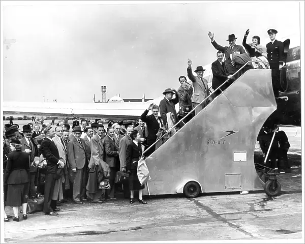 Passengers for the worlds first jet airliner service are shepherded aboard the BOAC