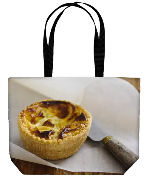 Little Quiche Lorraine on curled greaseproof paper with knife credit: Marie-Louise
