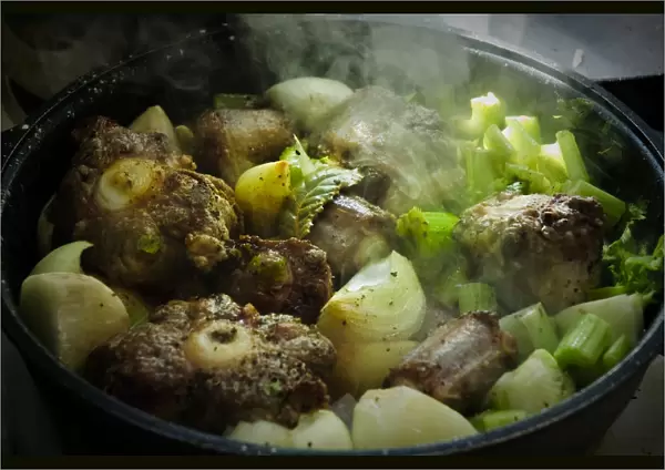 Oxtail casserole with onions and celery being started on top of stove before being