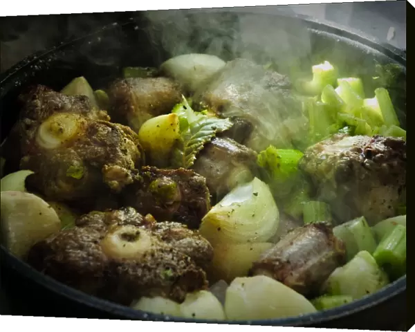 Oxtail casserole with onions and celery being started on top of stove before being