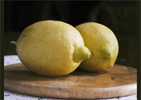 Two whole yellow lemons from Majorca on wooden board credit: Marie-Louise Avery