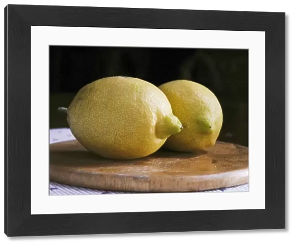Two whole yellow lemons from Majorca on wooden board credit: Marie-Louise Avery