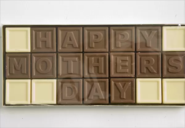 Chocolate letters spelling Happy Mothers Day in cellophane box as Mothers day