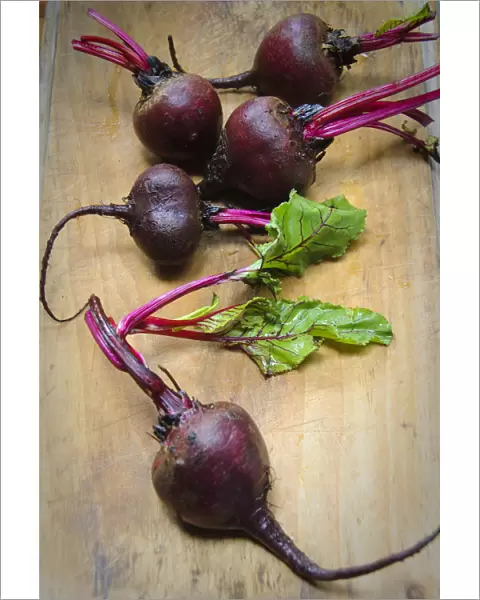 Whole fresh raw beetroots on wooden board credit: Marie-Louise Avery  /  thePictureKitchen