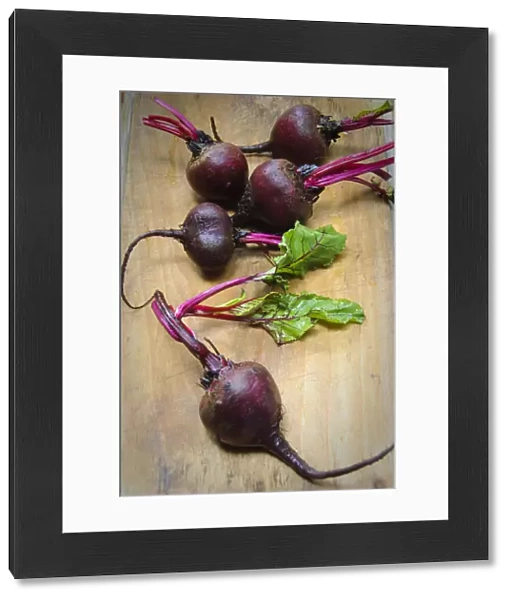 Whole fresh raw beetroots on wooden board credit: Marie-Louise Avery  /  thePictureKitchen