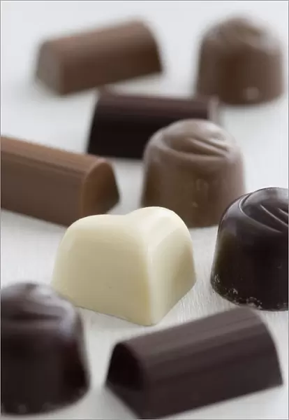 A selection of white, dark, and milk chocolates on white surface. credit: Marie-Louise