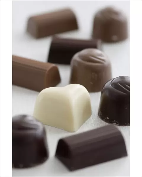 A selection of white, dark, and milk chocolates on white surface. credit: Marie-Louise