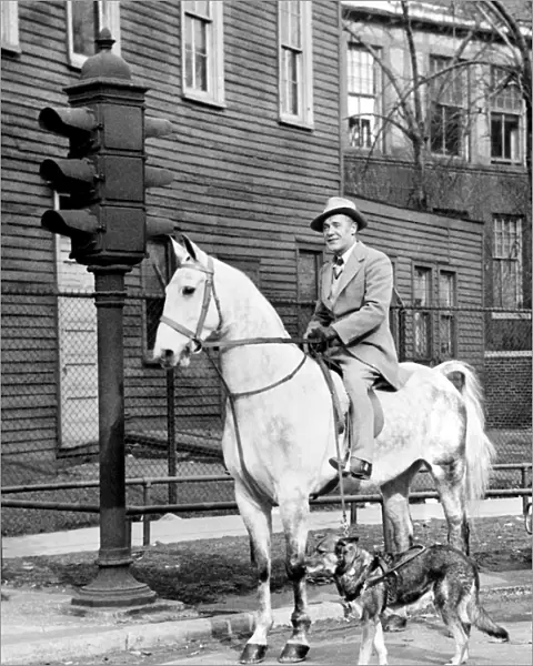Mr Roberts Coleman on his horse Northern Star is halted at a Chicago road crossing