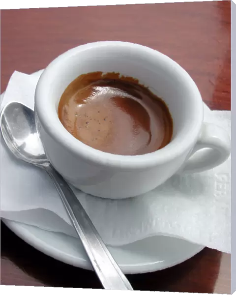 Small cup of strong espresso coffee, served in outdoor cafe in Amalfi, Italy credit