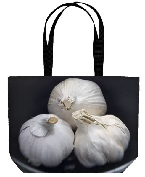 Three whole bulbs of garlic in black bowl credit: Marie-Louise Avery  /  thePictureKitchen