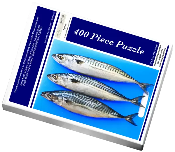 Three fresh whole mackerel on blue fish chopping board credit: Marie-Louise Avery