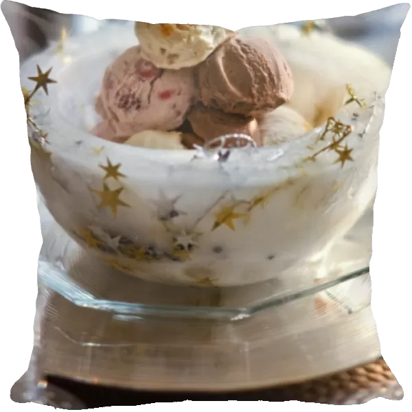 Ice bowl with stars holding balls of mixed icecreams for Christmas party credit