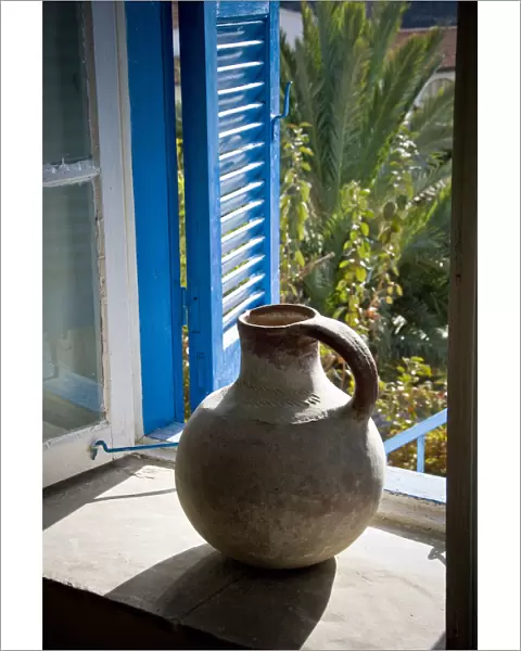 A large earthenware jug on the window sill of a Cypriot house in southern (Greek)