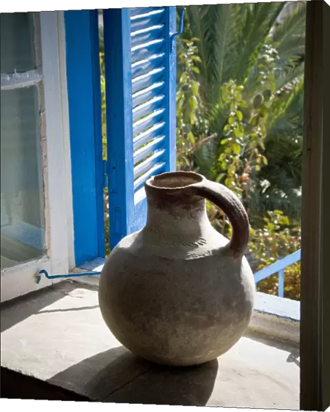 A large earthenware jug on the window sill of a Cypriot house in southern (Greek)