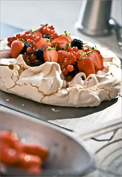 Pavlova with fresh berries on kitchen worktop credit: Marie-Louise Avery  /  thePictureKitchen
