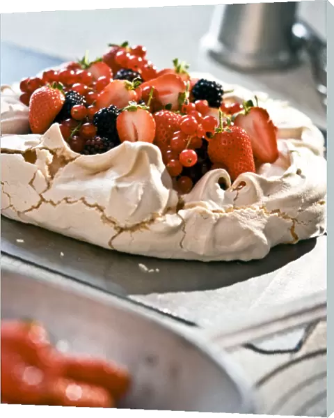 Pavlova with fresh berries on kitchen worktop credit: Marie-Louise Avery  /  thePictureKitchen