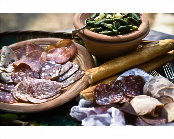 Selection of Italian cold, cired meats and salamis, with gherkins and French bread
