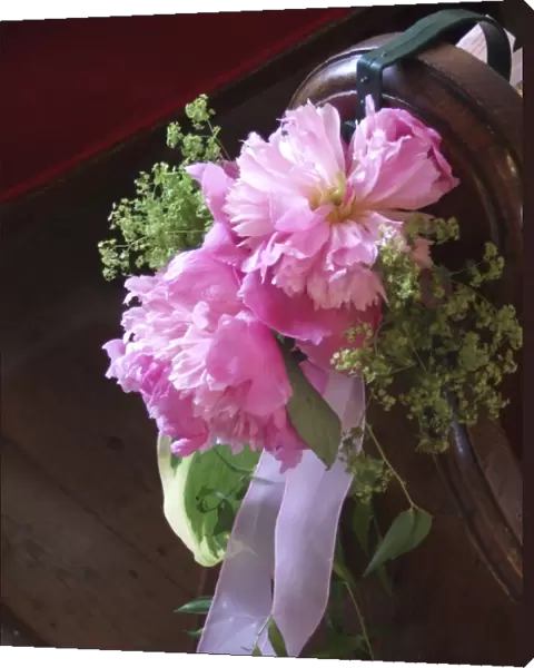 Paeonies and alchemilla mollis as pew end decoration, for summer wedding in country