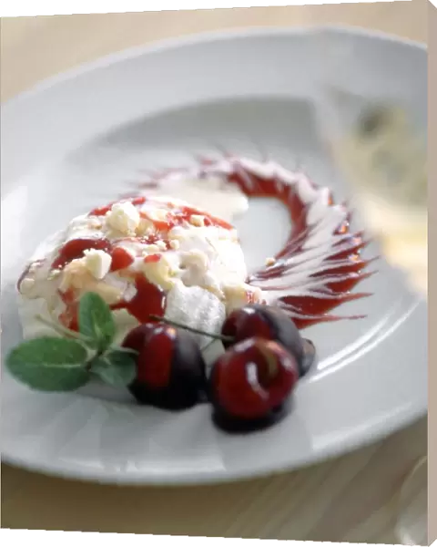 Sophisticated dessert of portion of cherry pavlova with cherries dipped in chocolate