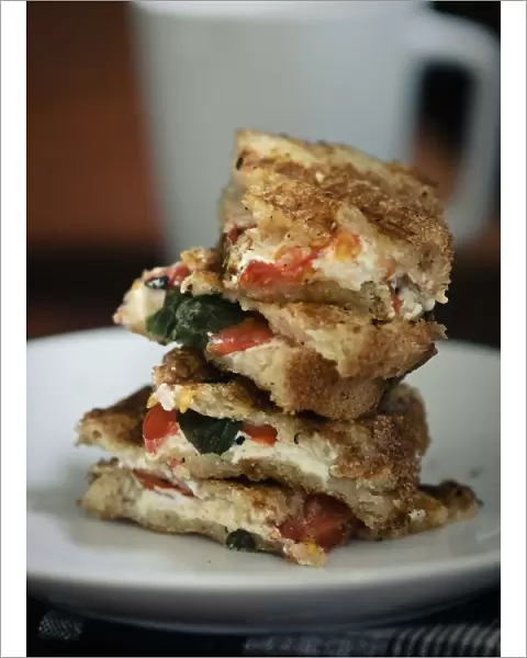 Toasted sandwich of gluten free bread with goats cheese feta, tomatoes and basil