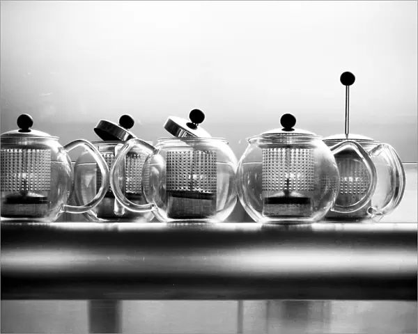 Glass Bodum teapots on metal shelf in restaurant credit: Marie-Louise Avery  /  thePictureKitchen