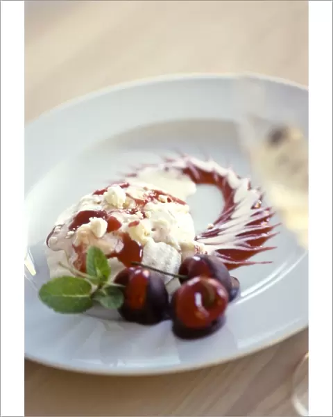 Spectacular, dessert of meringue with vanilla ice cream, cherry coulis and fresh