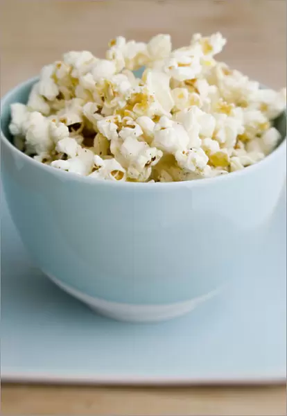 Freshly popped pocorn in pretty blue bowl credit: Marie-Louise Avery  /  thePictureKitchen