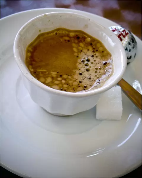 Small handleless cup of strong Turkish coffee on cafe table credit: Marie-Louise