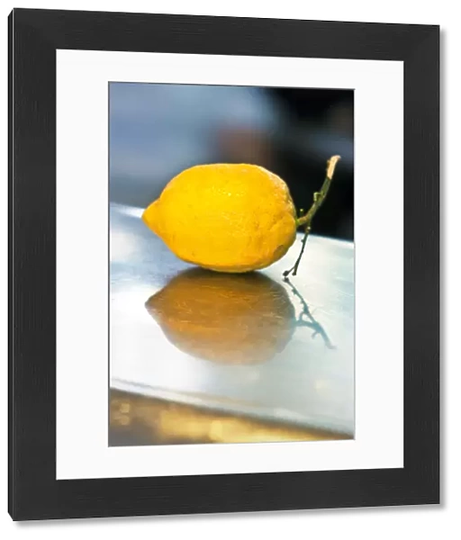 Single yellow lemon on stainless steel counter credit: Marie-Louise Avery  /  thePictureKitchen