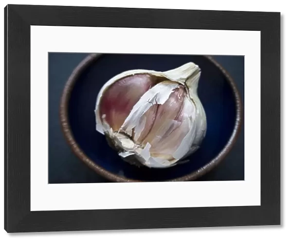 Single bulb of garlic broken open in small bowl credit: Marie-Louise Avery  /  thePictureKitchen