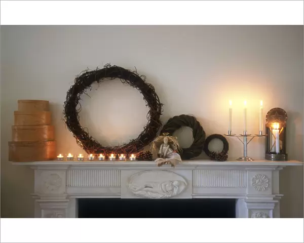 Chimney piece in pale interior with shaker style chritmas decorations and objects
