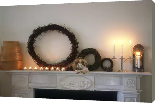 Chimney piece in pale interior with shaker style chritmas decorations and objects