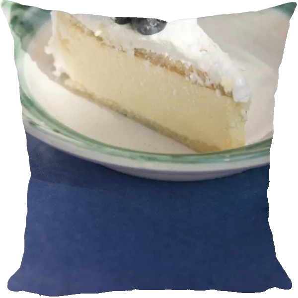 Slice of celebration gateau of light lemon and passionfruit mousse with soft meringue
