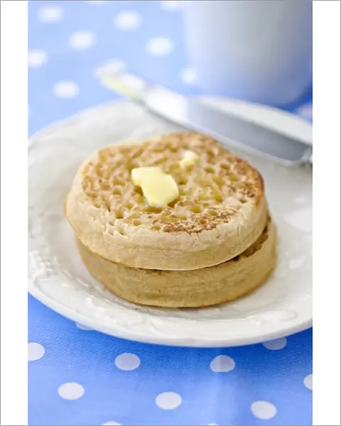 Hot buttered crumpets on white plate credit: Marie-Louise Avery  /  thePictureKitchen
