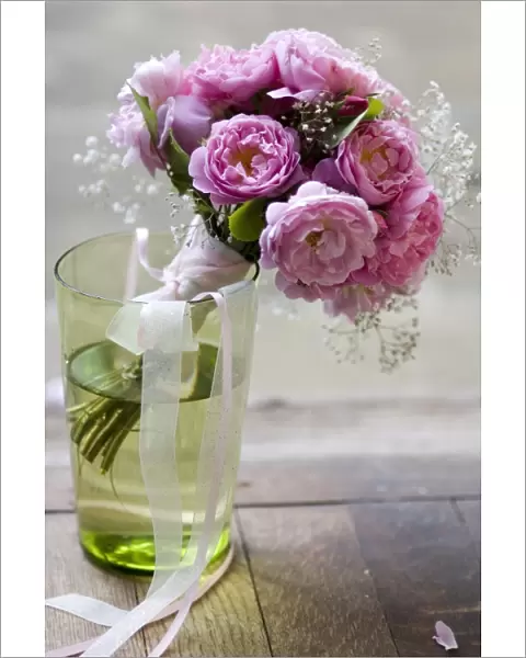 Pink peonies with gypsophila tied into simple posy style wedding bouquet credit