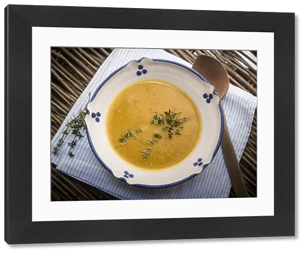 Soup of squash roasted with garlic and thyme, served in blue and white bowl with