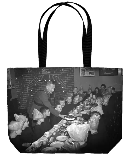 Boys being served their Christmas dinner by an officer at the Army Bands School in