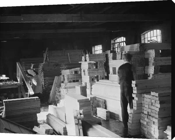 A joiner works on a piece at the G Ellis joinery works in Hackney. 7 April 1938