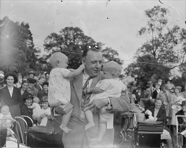 Sidcup Jubilee fete. Mr W Brown holds up twins at the baby show. 1939