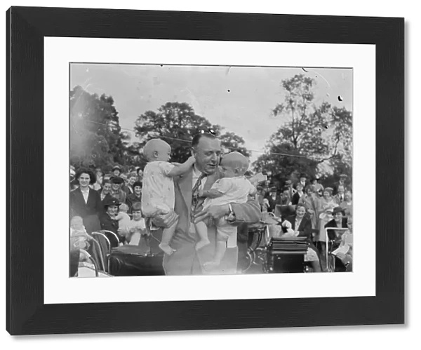 Sidcup Jubilee fete. Mr W Brown holds up twins at the baby show. 1939