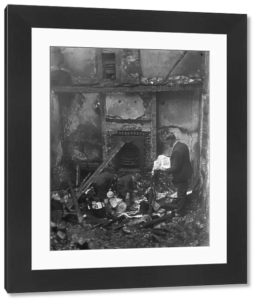 Looking through what is left behind following a cottage fire in Chelsfield, Kent