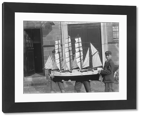 Boys hold up a model sailing ship at the handicraft exhibition in Dartford, Kent