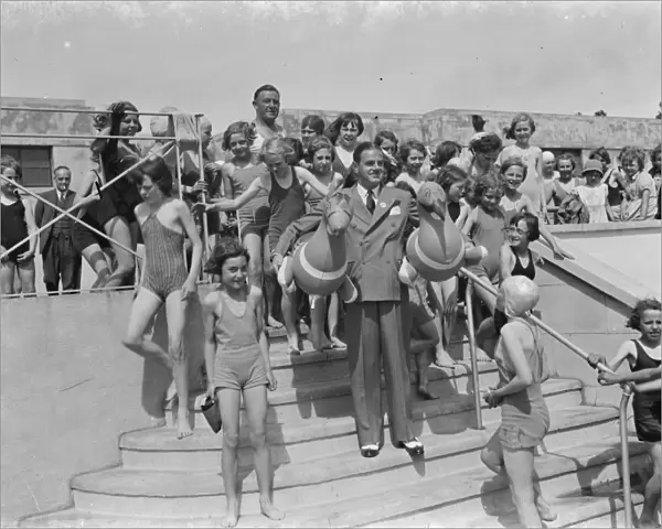 The Swanscombe Baths in Kent. Mr Behar poses with two Inflatable birds. The children