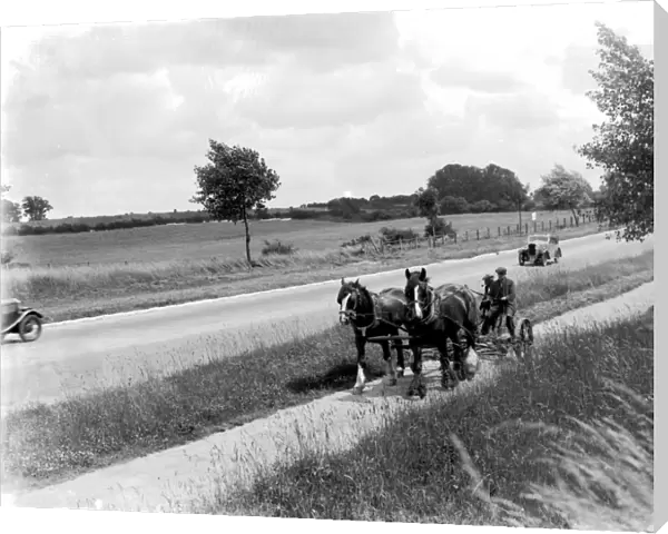 Country roads were almosts empty of traffic. Here in 1936 a car passes a horsedrawn mower