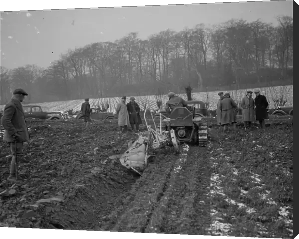 Farmers watch a ploughing demonstration with the new Melotte tractor