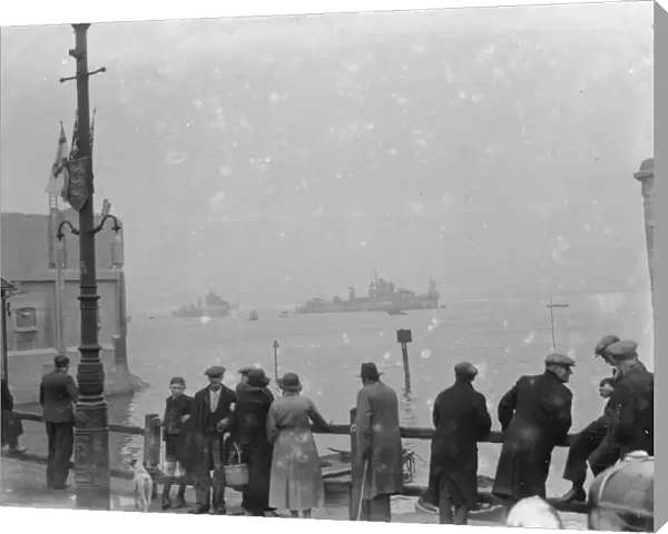 People gather on the river side to watch the Home Fleet on the Thames at Erith, London