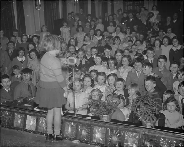 A little girl entertains the audience of children at the childrens party at the