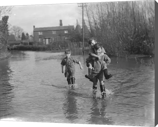 Boys wade through the floods in Beltring, Kent. 1936